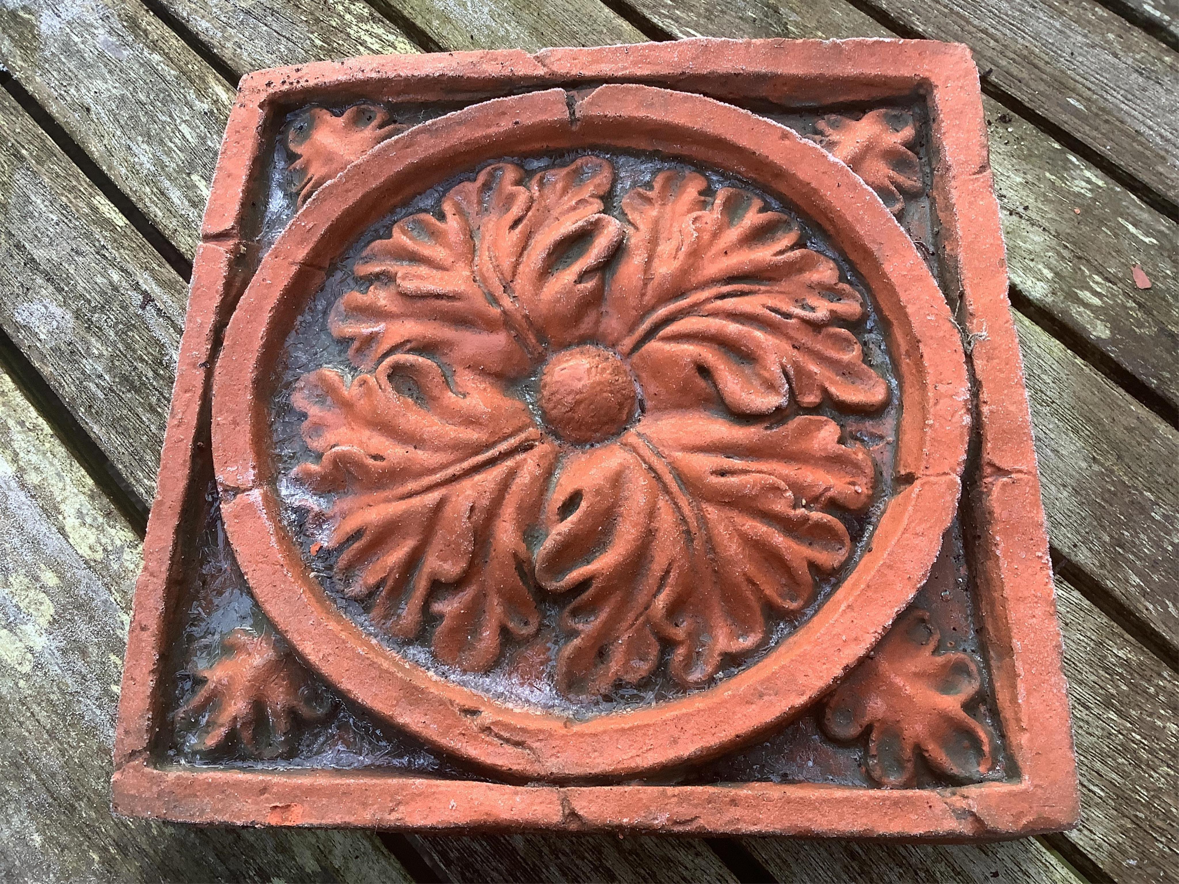 Six terracotta decorative tiles, largest width 21cm. Condition - fair